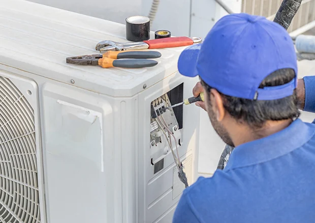 Technician responding to an outdoor air conditioning service call